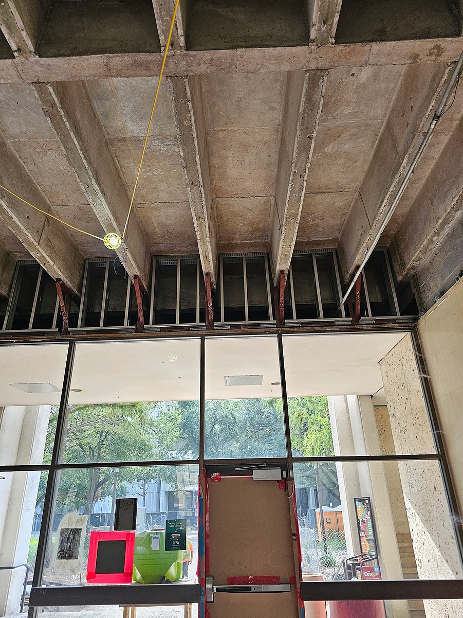 Construction team installing drop ceiling grid